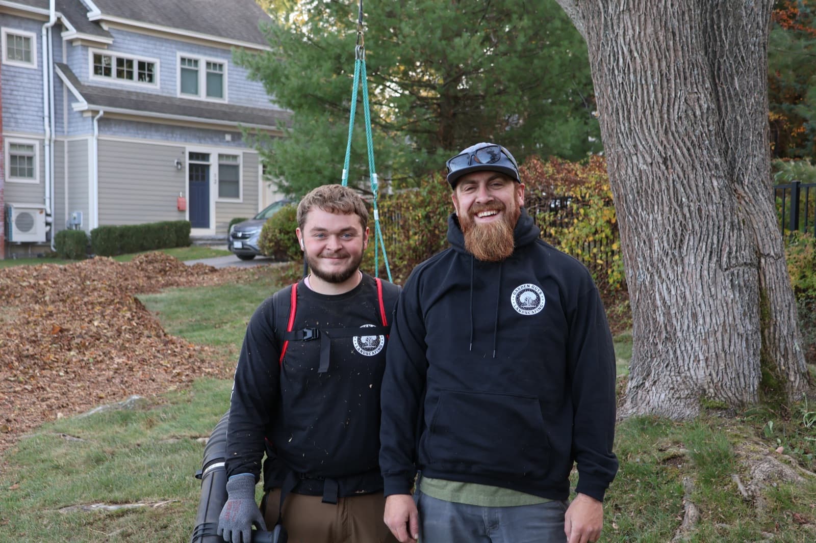Two Garden Guys crew members on a fall cleanup