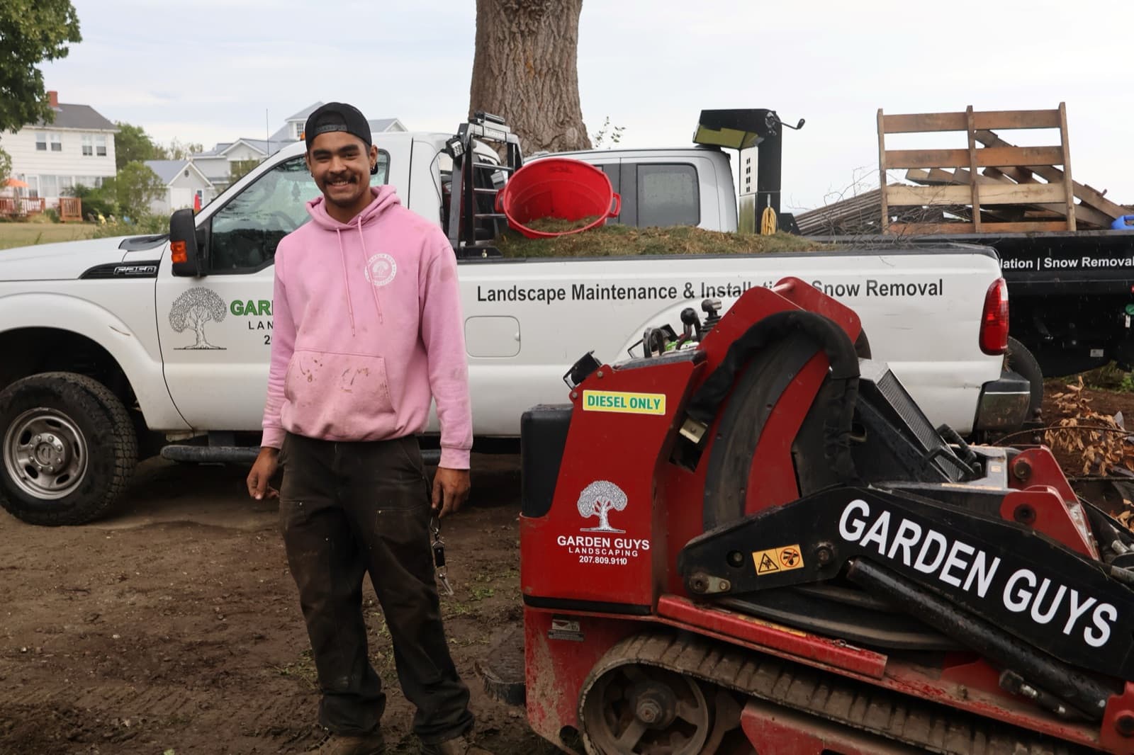 Garden Guys crew and truck at a coastal job site