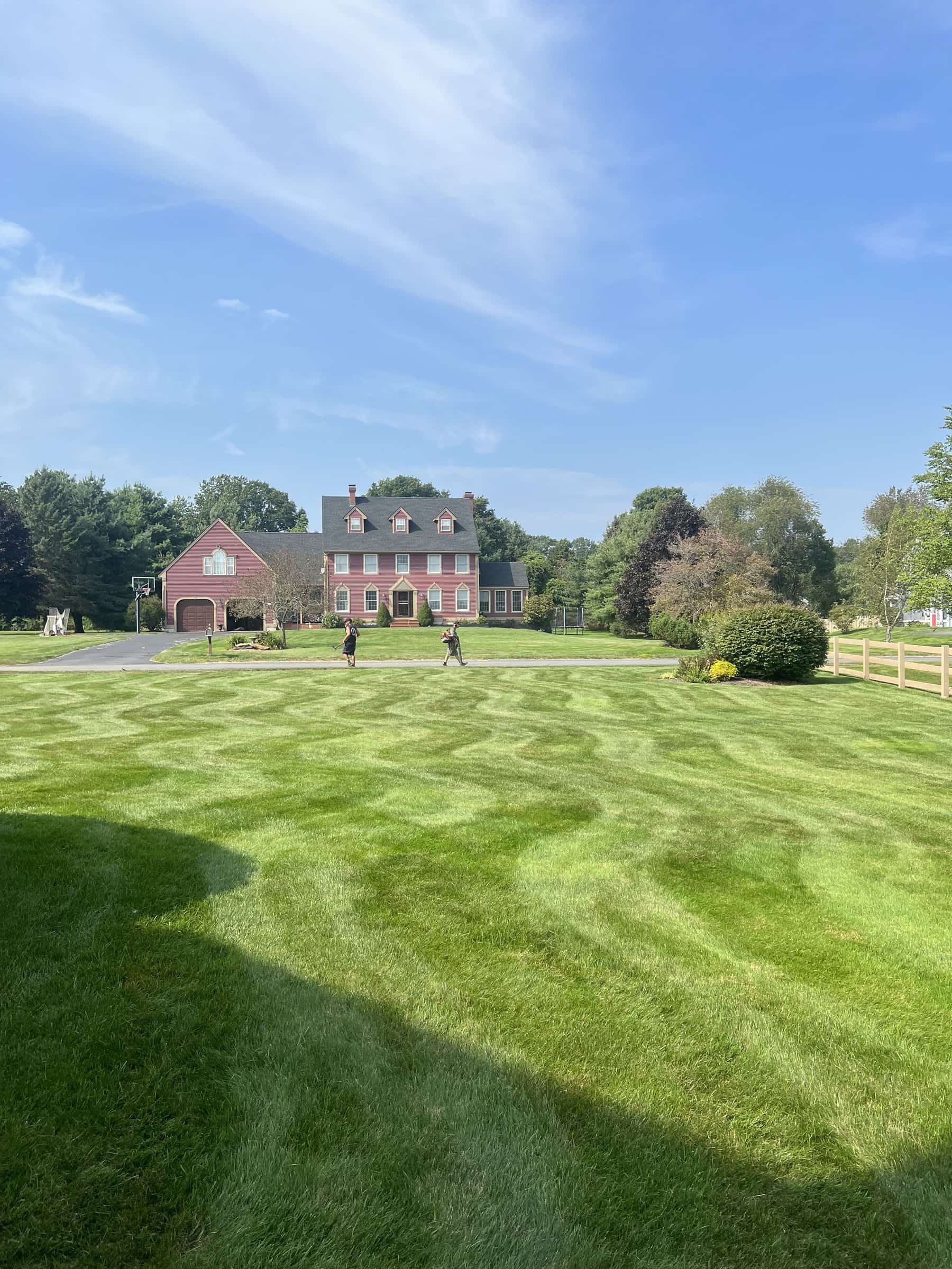 Striped lawn at a brick estate